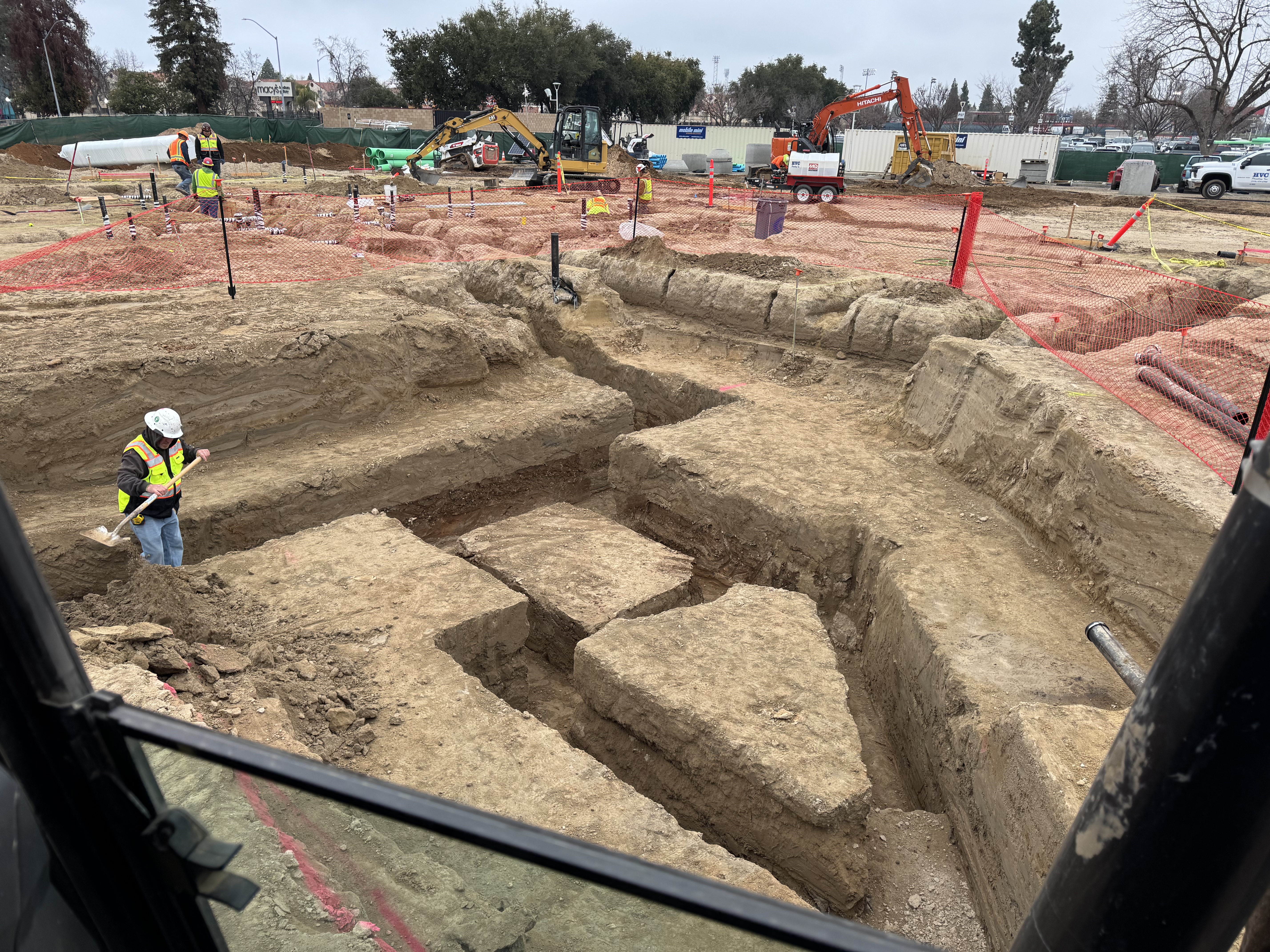 Elevated view of large commercial excavation site with equipment and crew in Northern California