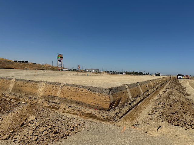 Wide-span laser screed machine in operation on a large warehouse slab in Northern California