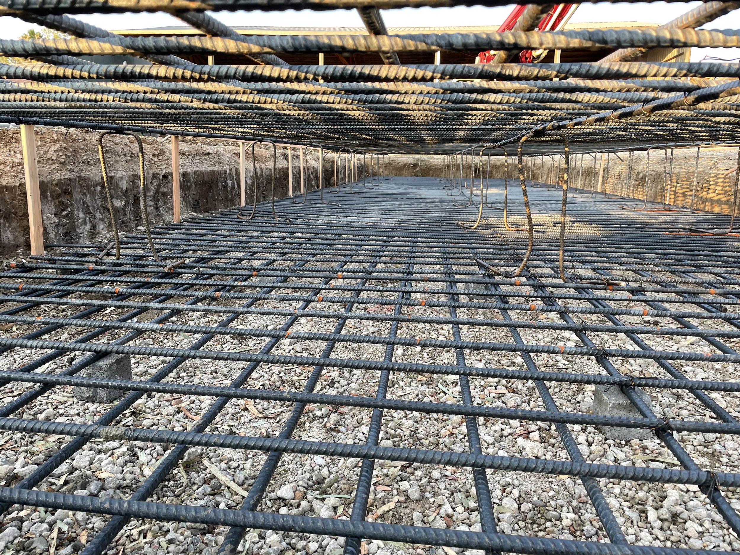 Liaison Concrete Construction crew power-trowel finishing a large commercial concrete slab at dusk in Northern California