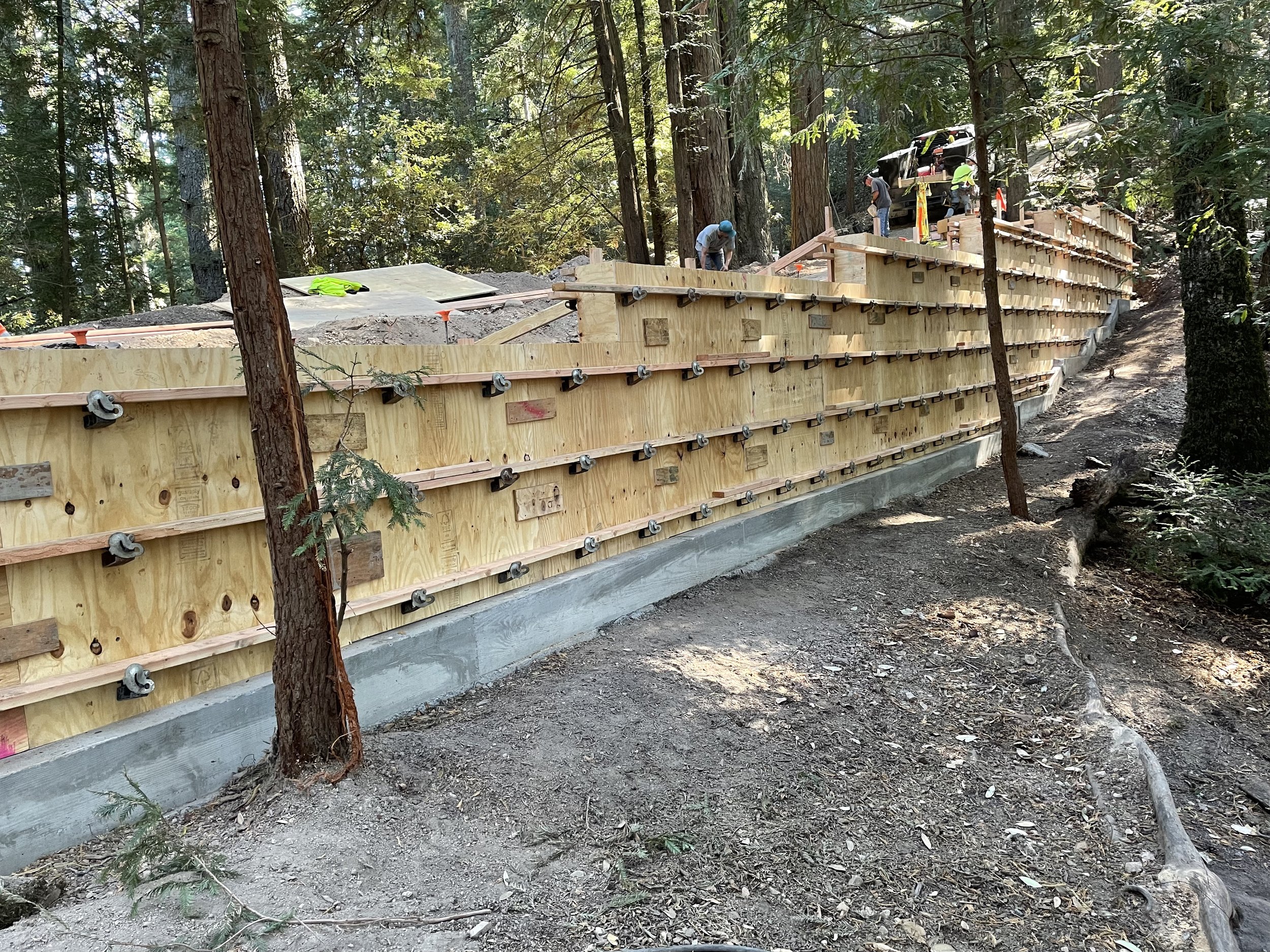 Liaison Concrete crew constructing a large concrete retaining wall on a commercial site in Northern California